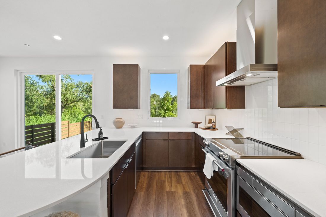 Perch kitchen with range and tile backsplash