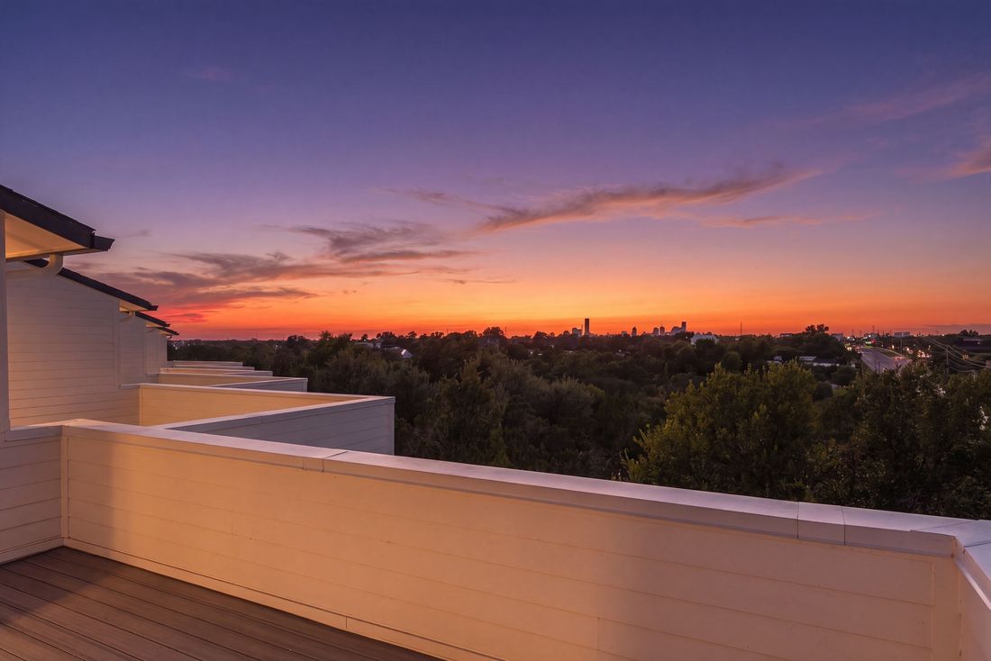 Rooftop terrace at twilight with the downtown Austin skyline in the distance
